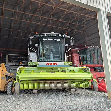 Claas Jaguar combine with Case 95XT Skid Steer and other harvesting equipment